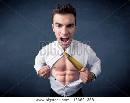 Businessman tearing off his shirt and showing mucular body concept on background
