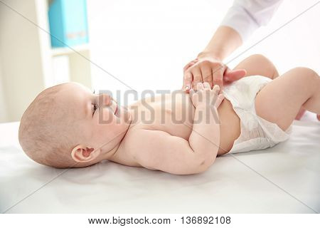 Doctor doing exercises with baby