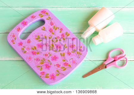 Decoupage cutting board kitchen wall decoration. Idea for painting and decoupage on a chopping board. Handmade kitchen decor. Glue, paint, scissors. Tools and materials for for creative work