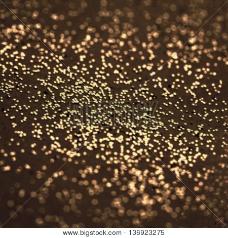 Defocused Dark gold glitter. Abstract Christmas twinkled magic background with gold glittering texture. Golden Festive lights