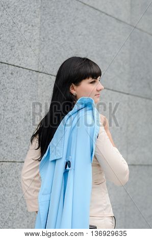 Long-haired Brunette In A White Suite With A Turquoise Coat