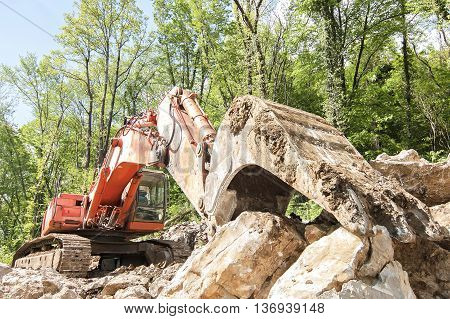 Excavator with big shovel to work with rocks