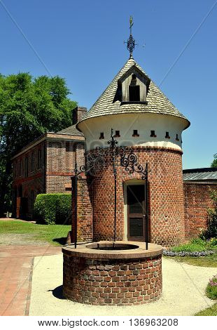 New Bern North Carolina - April 24 2016: Drinking water well and dovecote behind the Stables wing at 1770 Tryon Palace