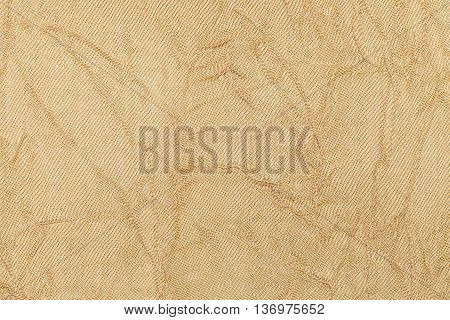 light beige wavy background from a textile material. Fabric with natural texture clousup. Upholstery fabric pleated.