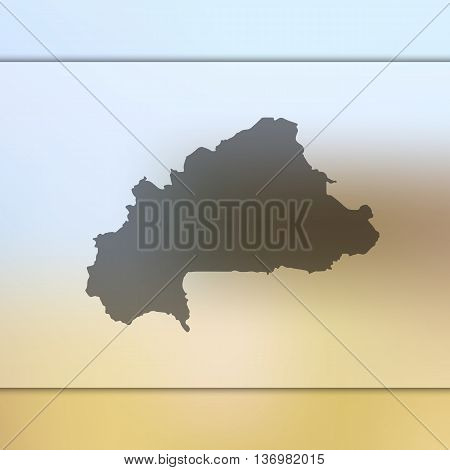 Burkina Faso map on blurred background. Blurred background with silhouette of Burkina Faso.