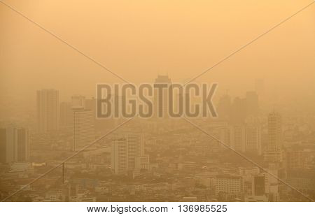 Low visibility caused by pollution problem in urban area during golden sunset Bangkok THAILAND.