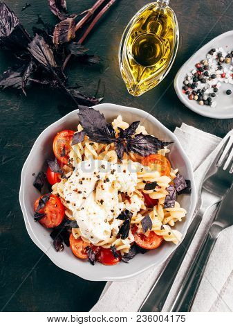 Tasty Italian Fusilli Pasta With Cherry, Mozarella Or Buratta Cheese And Fresh Basil. Dish With Past