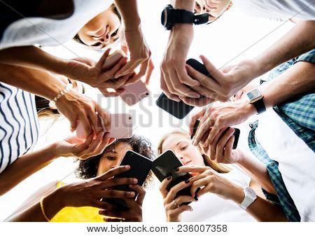 Young adults using smartphones in a circle social media and connection concept