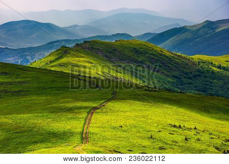 Path Through Grassy Meadow On Hillside. Beautiful Summer Landscape Of Great Carpathian Water Dividin