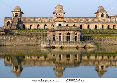 Jahaz Mahal , Ship Palace And Blue Water Lake In Sunrise. Mandu, Madhya Pradesh, India. Old Indian A