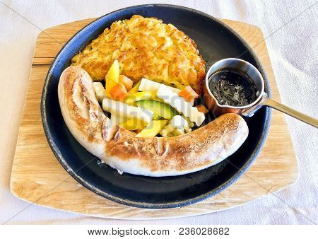 Wurstel With Rosti, A Typical Dish From The Engadin Region In Saint Moritz