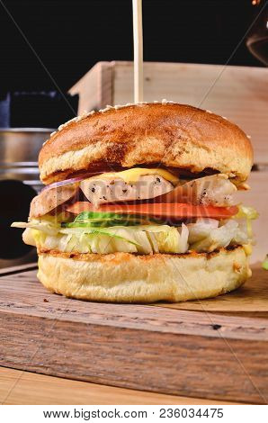 Top View Fresh Homemade Burger With Chicken, Salad, Cheese, Onion, Cucumber, Tomato, Sause And Dark 