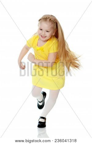 A Lovely Little Round-faced Blonde Girl, With Very Long Beautiful Hair, In Short Skirts And Yellow J