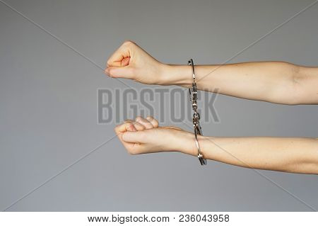 Arrested Woman Handcuffed Hands. Prisoner Or Arrested Terrorist, Close-up Of Hands In Handcuffs Isol