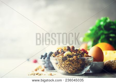Organic Ingredients For Healthy Breakfast - Berries, Milk, Egg, Oatmeal On Grey Concrete Background.