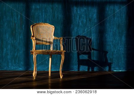 Old Chair On A Blue Wall Background