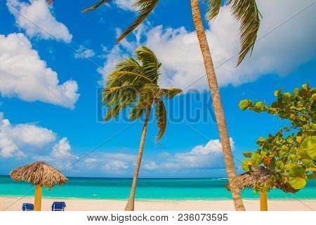 Holguin, Cuba, Playa Esmeralda. Beautiful Caribbean Sea Turquoise Blue Color And Palm Trees On The B