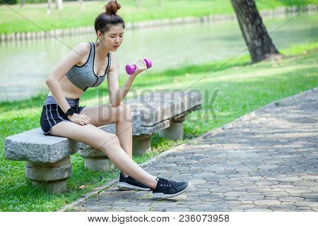 Beautiful Sport Fitness Girl In Sportswear Doing Fitness Exercise Sitting And Lifting Weigth With Du