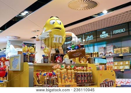 WARSAW, POLAND - CIRCA NOVEMBER, 2017: M&M candy yellow character on display at Aelia Duty Free store at Warsaw Chopin Airport.