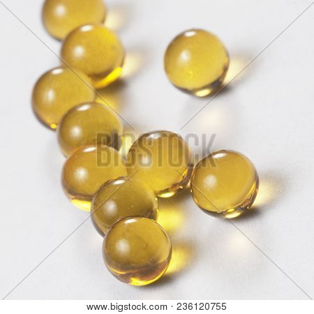Yellow Capsules Over The Light Background Macro