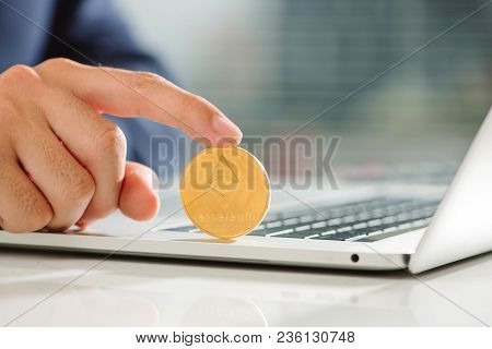 Man Hold Gold Bitcoin Over Office Desk. Bitcoin Payment Concept.