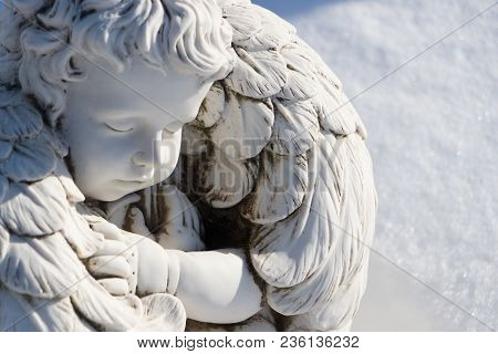 Sleeping Angel Statue.angel Guardian Sleeping In White Snow Background