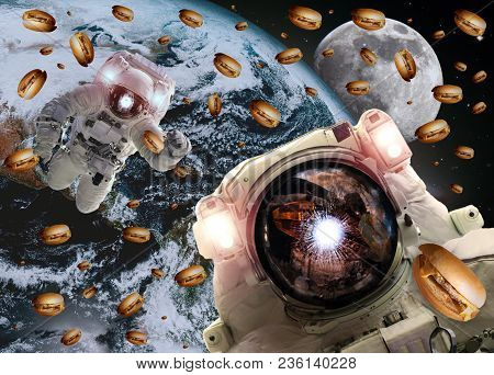 Astronauts In Outer Space With Cheseburgers On The Earth And The Moon On The Background. Elements Of