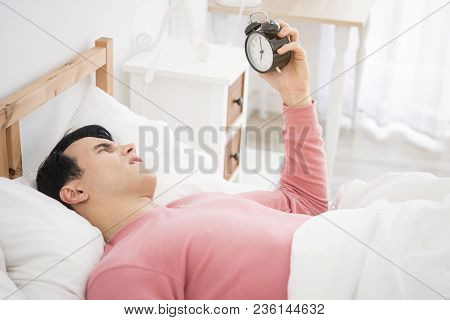 Man Wake Up Doing Turn Off Alarm Clock In The Morning. He Tired And Lazy Do Work.