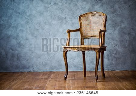 Old Chair On A Gray Wall Background