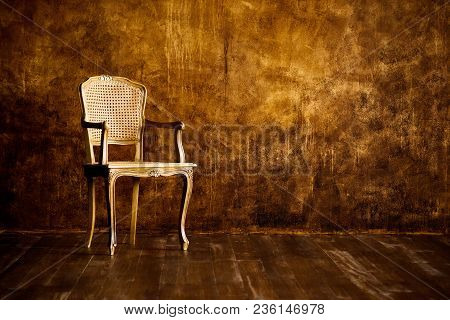 Old Chair On A Brown Wall Background