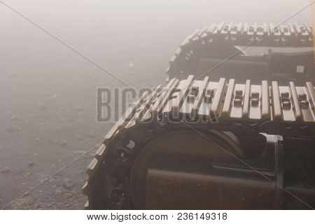 Big Caterpillar Tractors On The Island Of Sicily, Italy. Mystical Metal Caterpillars In The Fog On M