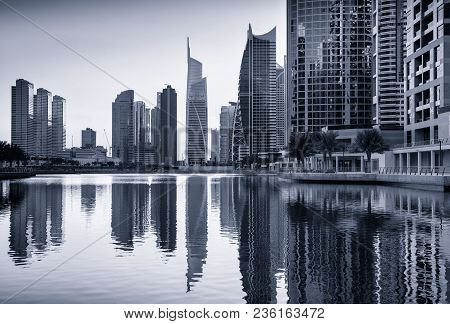 Dusk Skyline Of Jumeirah Lakes Towers With Clear Reflections, Dubai, United Arab Emirates