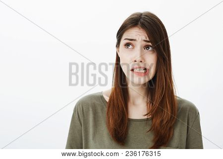 Girl Imagining Bad Consequences Of Her Action. Regretting Worried Beautiful Woman In Dark-green T-sh