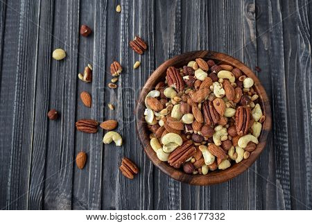 Nuts Mix Almonds, Cashews, Macadamia, Peanuts, Walnuts, Pecans, Pine Nuts, Pistachios In A Wooden Pl