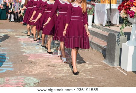 Elegant High School Graduates In Identical Marsala Dresses