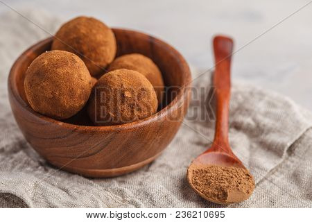 Homemade Healthy Vegan Raw Energy Truffle Balls With Carob In Wooden Bowl.