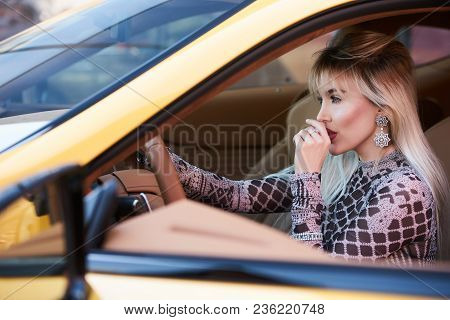 Beautiful Woman With Yellow Sport Car. Young Female Model With Lixury Diamonds Jewerly Sitting In A 
