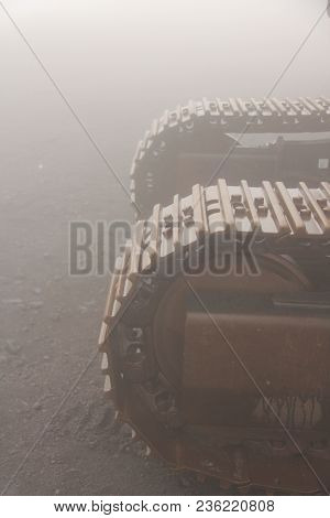 Big Caterpillar Tractors On The Island Of Sicily, Italy. Mystical Metal Caterpillars In The Fog On M
