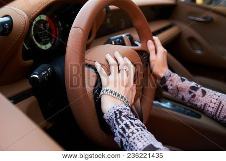 Beautiful Woman With Yellow Sport Car. Young Female Model With Lixury Diamonds Jewerly Sitting In A 