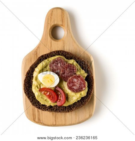Open  faced sausage sandwich canape or crostini on a wooden serving board  isolated on white background closeup. Top view.