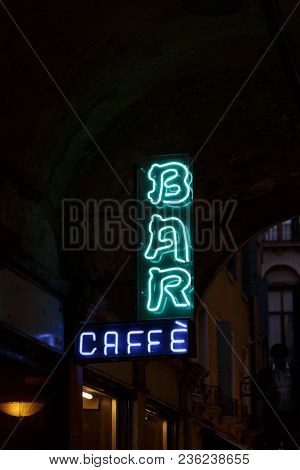 A Neon Bar Caffe Sign In Night Time Venice