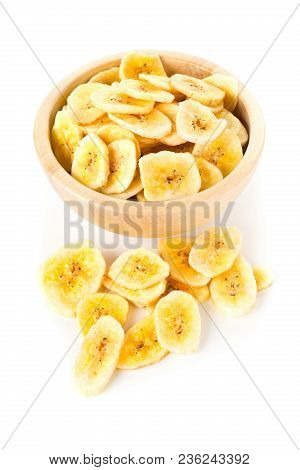 Heap Of Dried Banana Chips Snack In Wooden Bowl Over White Background