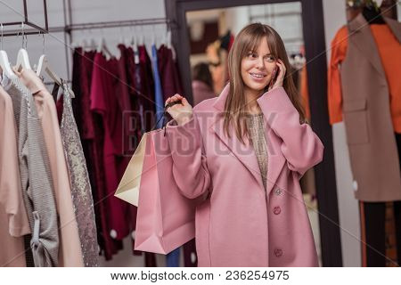 Attrractive girl with shopping bags in the store