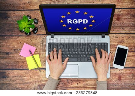 Woman Using A Computer With Flag Of European Union With Rgpd Word Inside On The Screen