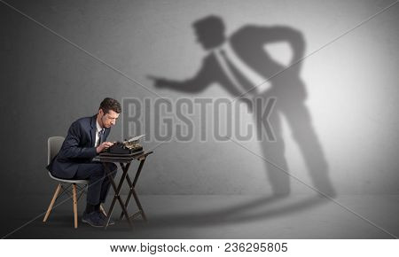 Little man working and a big shadow arguing with him