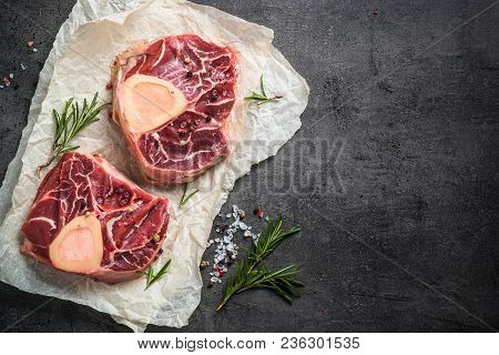 Raw Beef Steak Osso Bucco On Black Stone Slate Background. Marble Meat. Top View With Copy Space.