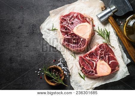 Raw Beef Steak Osso Bucco On Black Stone Slate Background. Marble Meat. Top View With Copy Space.