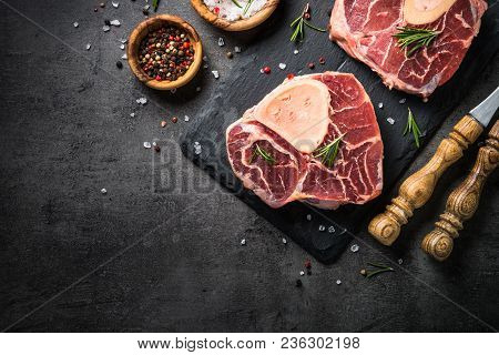 Raw Beef Steak Osso Bucco On Black Stone Slate Background. Marble Meat. Top View With Copy Space.