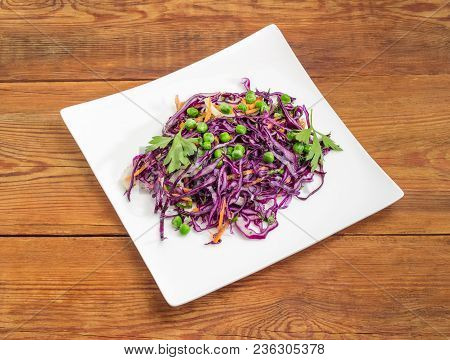 Vegetable Salad Of The Fresh Chopped Red Cabbage, Carrot, Onion, Green Pea And Greens On A White Squ