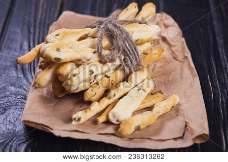 Crispy Grisini With Olive On Old Brown Paper In Studio